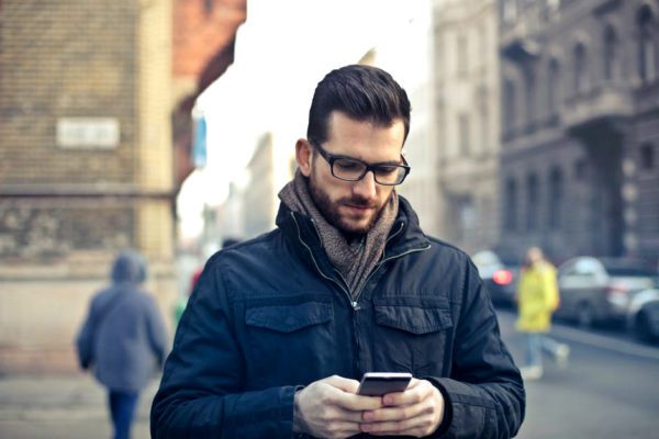 a man using his cell phone in the street