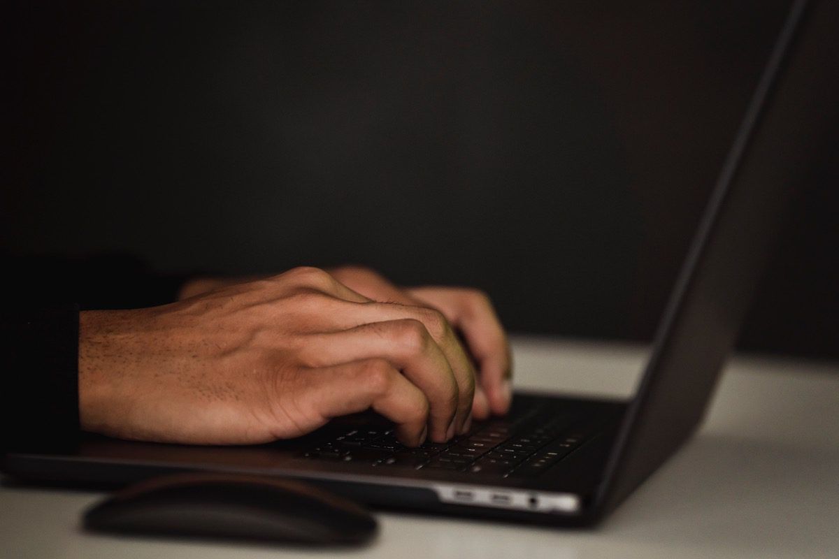 Hands typing on a laptop while researching treatment programs