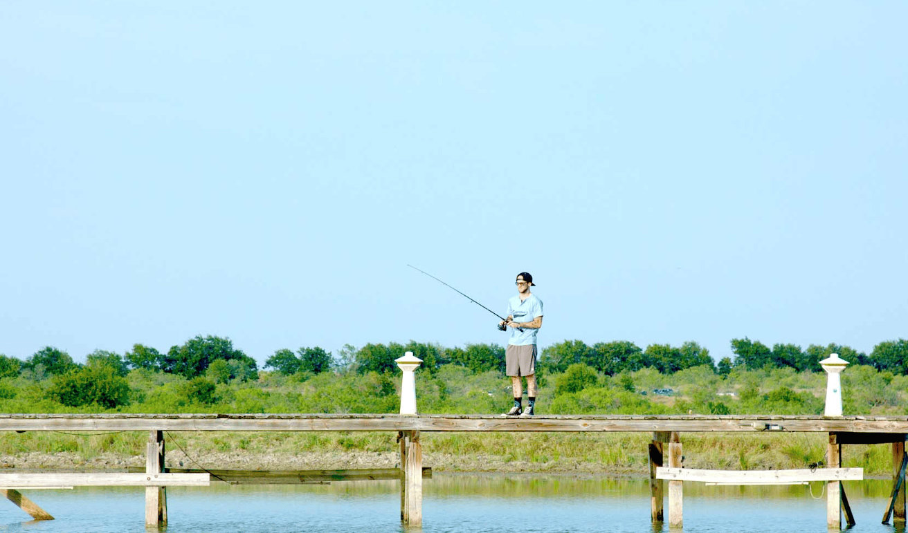 Resident fishing from the dock on the ranch pond
